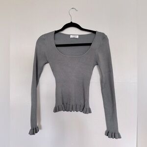 Baby blue knit long-sleeve top with ruffles by  The Workshop